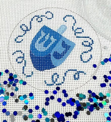 Kate Dickerson Needlepoint Collections Hanukkah Round with Clear Dome and Confetti Dreidel with Sparkly Streamers on White Needlepoint Canvas