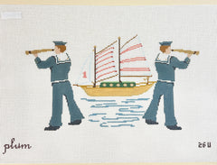 Needlepoint canvas by Plum Stitchery featuring two sailors carrying telescopes, flanking a sailing ship with pink-striped sails on blue water against a white canvas background.