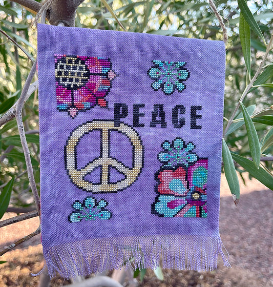 Jan Hicks Creates Peace Prayer Flag Cross Stitch Pattern