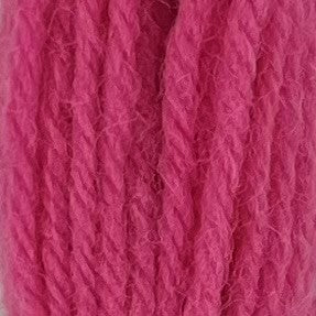 Close-up of medium bubble gum pink crewel wool thread with a soft, fuzzy texture and tightly twisted strands.