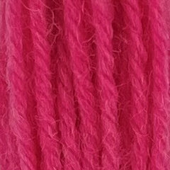 Close-up of dark bubble gum pink crewel wool thread with a soft, fuzzy texture and tightly twisted strands.