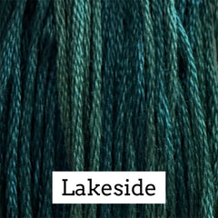 Close-up of deep teal cotton embroidery floss with subtle variegated blue-green tones.