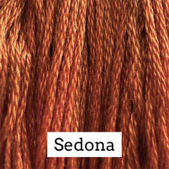 Close-up of warm rust‑red cotton embroidery floss with subtle lighter and darker tonal variation, labeled “Sedona.”