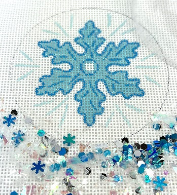 Kate Dickerson Needlepoint Collections Christmas Ornament with Clear Dome Cover and Confetti Light Blue Snowflake on Sparkly White Needlepoint Canvas