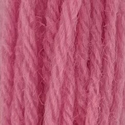 Close-up of bubble gum pink crewel wool thread with a soft, fuzzy texture and tightly twisted strands.