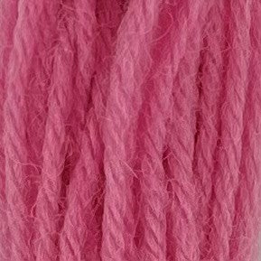 Close-up of medium bubble gum pink crewel wool thread with a soft, fuzzy texture and tightly twisted strands.