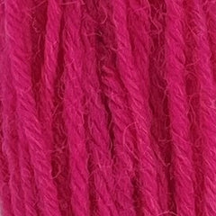 Close-up of dark pink crewel wool thread with a soft, fuzzy texture and tightly twisted strands.