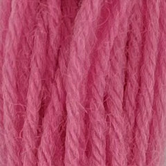 Close-up of medium bubble gum pink tapestry wool thread with a soft, fuzzy texture and tightly twisted strands.