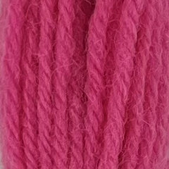 Close-up of medium dark bubble gum pink tapestry wool thread with a soft, fuzzy texture and tightly twisted strands.