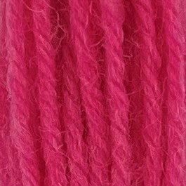 Close-up of dark bubble gum pink tapestry wool thread with a soft, fuzzy texture and tightly twisted strands.