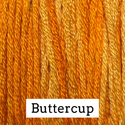 Close-up of bright golden‑yellow silk embroidery floss with subtle variegated orange and yellow tones, labeled “Buttercup.”