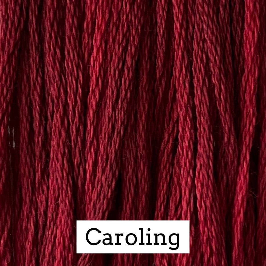 Close-up of deep burgundy cotton embroidery floss with subtle tonal variation, labeled “Caroling.”