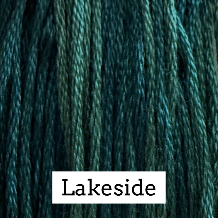 Close-up of deep teal cotton embroidery floss with subtle variegated blue-green tones.