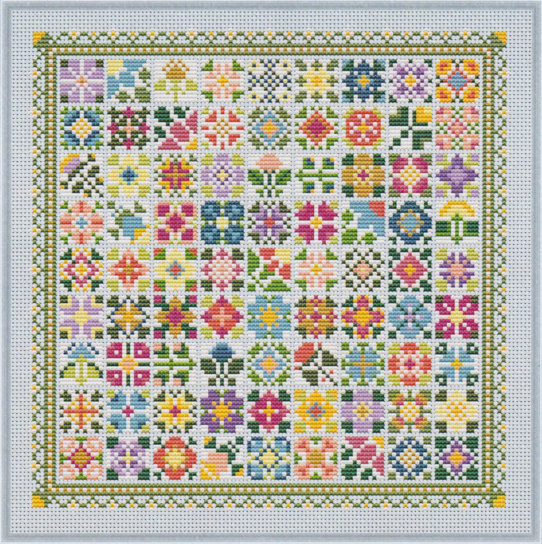 Colorful cross stitch made up of many small floral quilt‑block designs arranged in a mosaic grid with a decorative border.