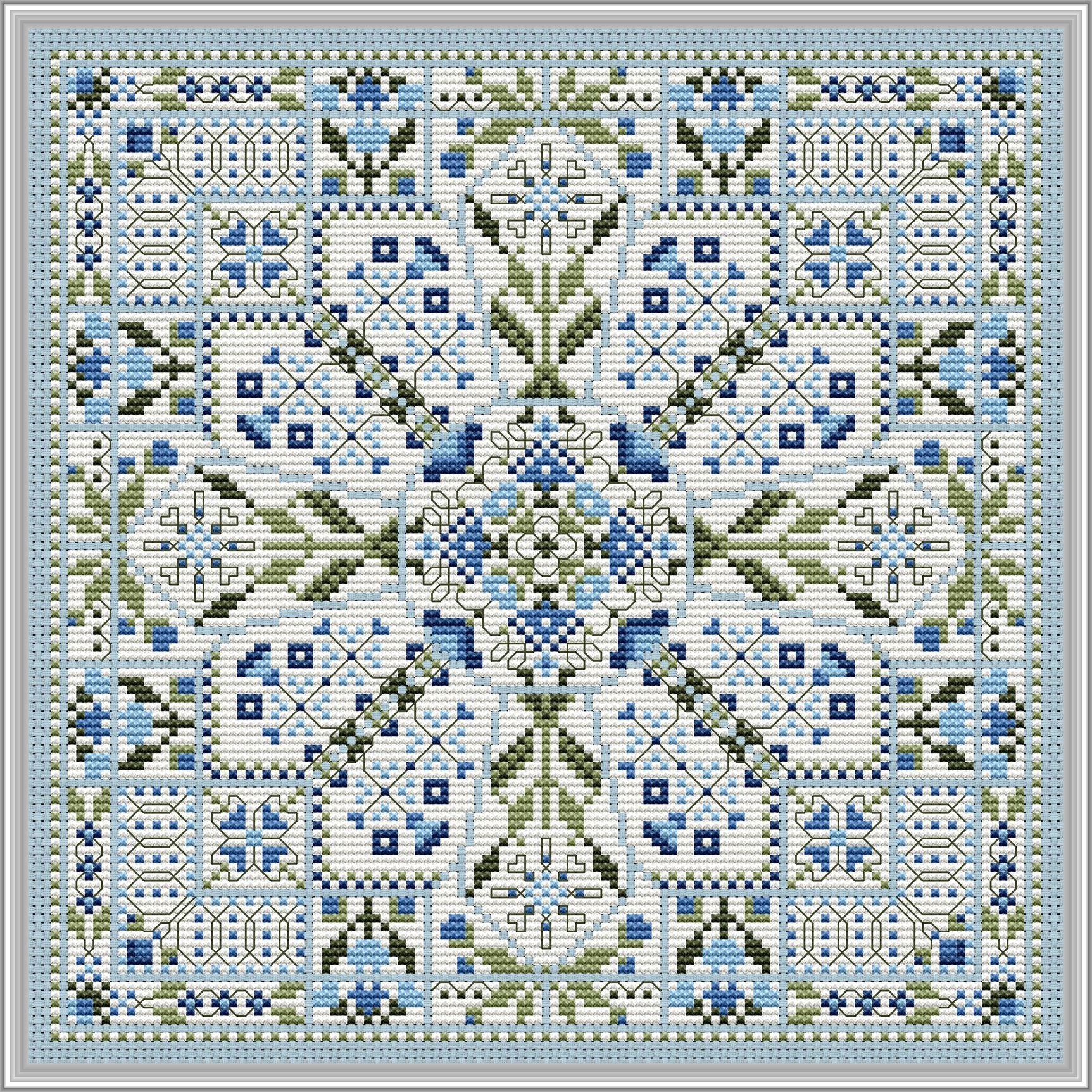 Symmetrical blue and green geometric cross‑stitch design with a central floral motif and repeating decorative borders.