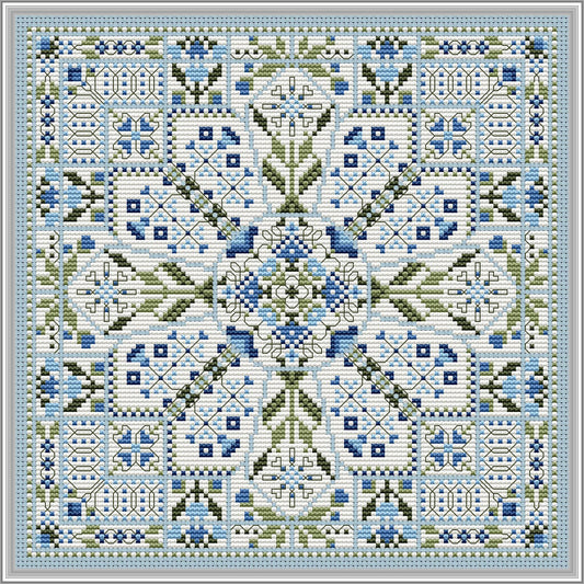 Symmetrical blue and green geometric cross‑stitch design with a central floral motif and repeating decorative borders.