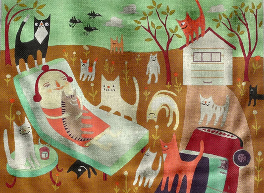 Needlepoint canvas depicting a whimsical outdoor scene with a lounging cat‑loving woman surrounded by many stylized cats, birds, trees, and a small house in warm earthy tones and soft pastels.