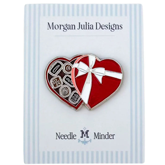 Heart‑shaped needle minder resembling an open box of chocolates on a Morgan Julia Designs card.