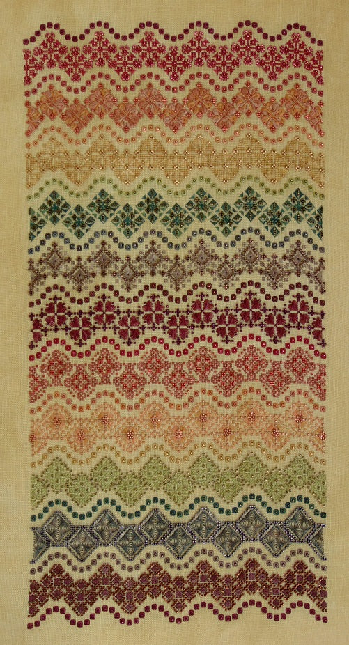 Cross stitch band sampler of colorful patterned motifs in a wave formation.