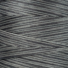 Close-up of gray overdyed embroidery floss wound tightly, showing subtle light and dark tonal variations in the strands.