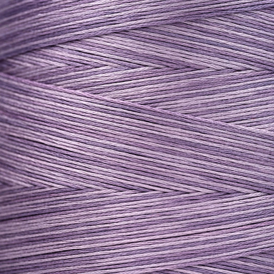 Close-up of lavender‑purple overdyed embroidery floss wound tightly, showing subtle shade variations in the strands.